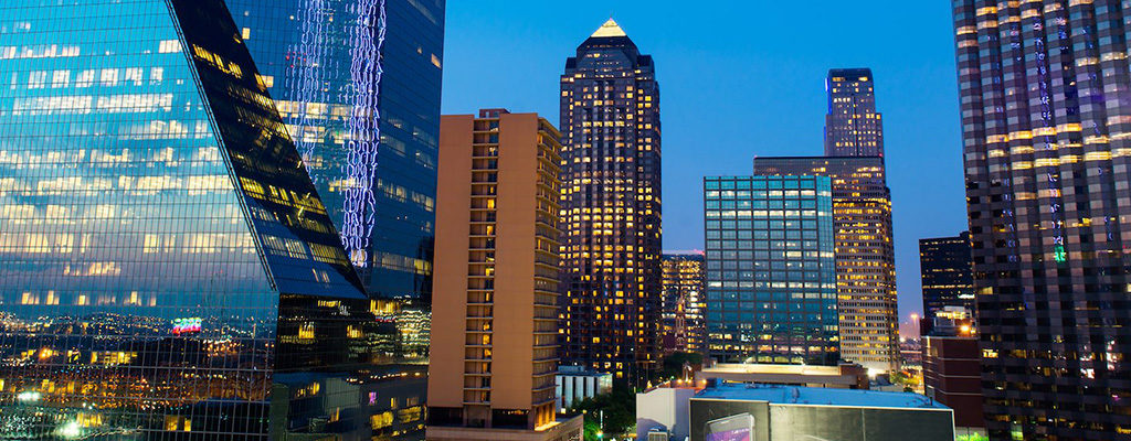 Dallas cityscape at night, a city served by Trailways charter bus rentals