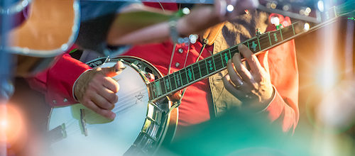 Banjo player in live music performance in Nashville, TN, a city served by Trailways bus service and charter bus rentals